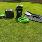 Pressure washing and gutter cleaning tools on a lawn.