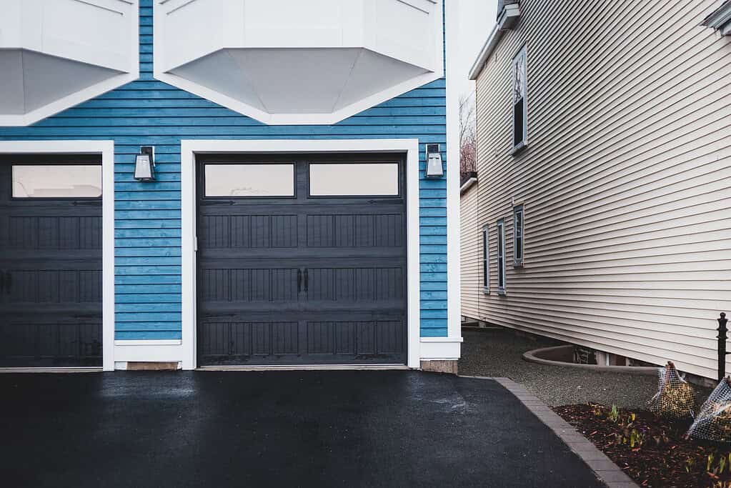Pressure washing garage doors in Staffordshire – clean and restored finish.
